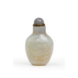 A Chinese white jade 'boy and peach' baluster snuff bottle Qing dynasty, 18th century The pale ...