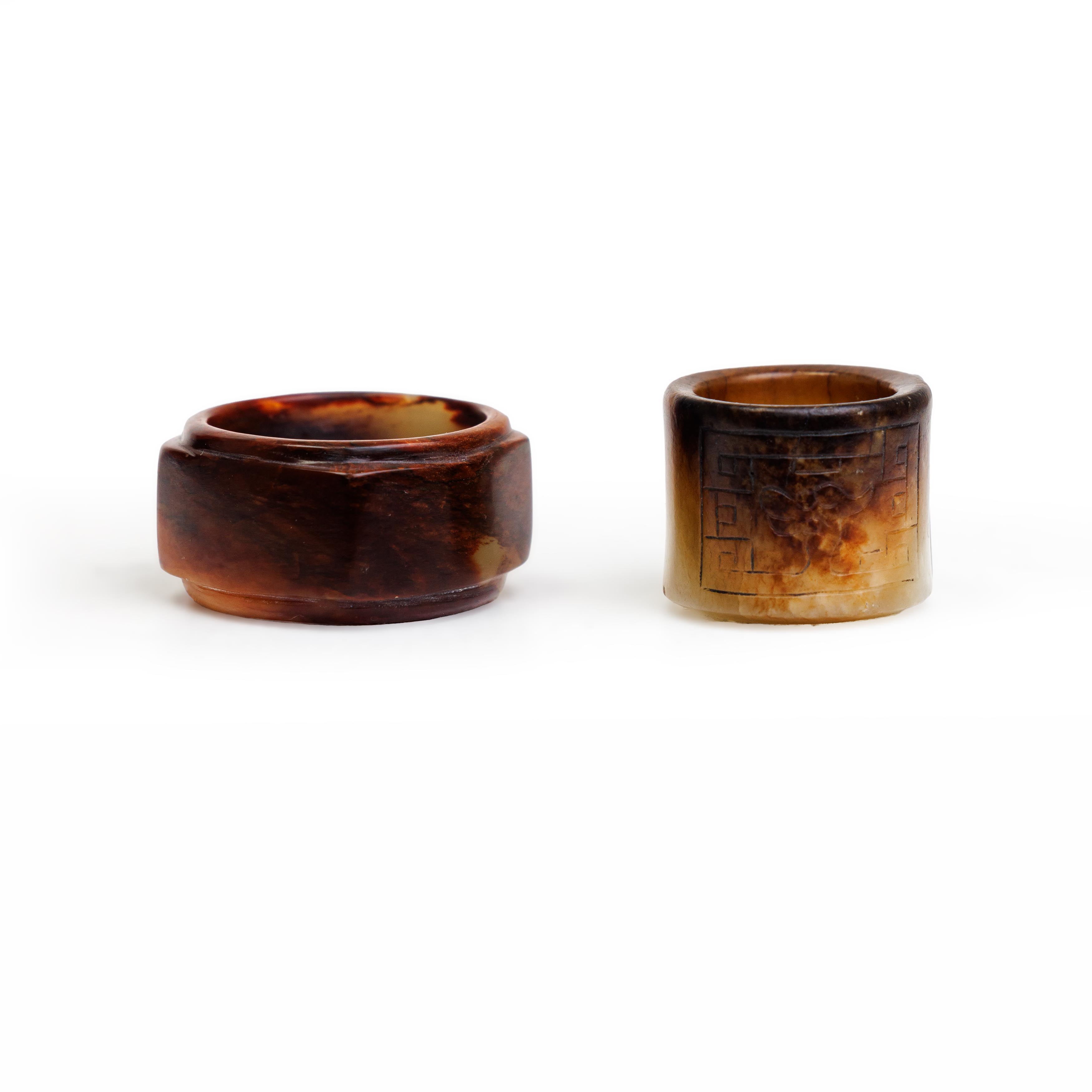 A Chinese russet jade archer's ring and a cong Qing dynasty, 19th century The archer's ring car...