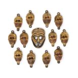 Thirteen gilt copper-alloy 'mask' pendants for a dakini's necklace 19th century Comprising twel...