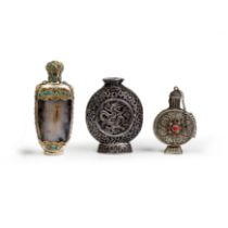 Three Chinese Mongolian-style white metal snuff bottles Late Qing dynasty - 20th century The fi...