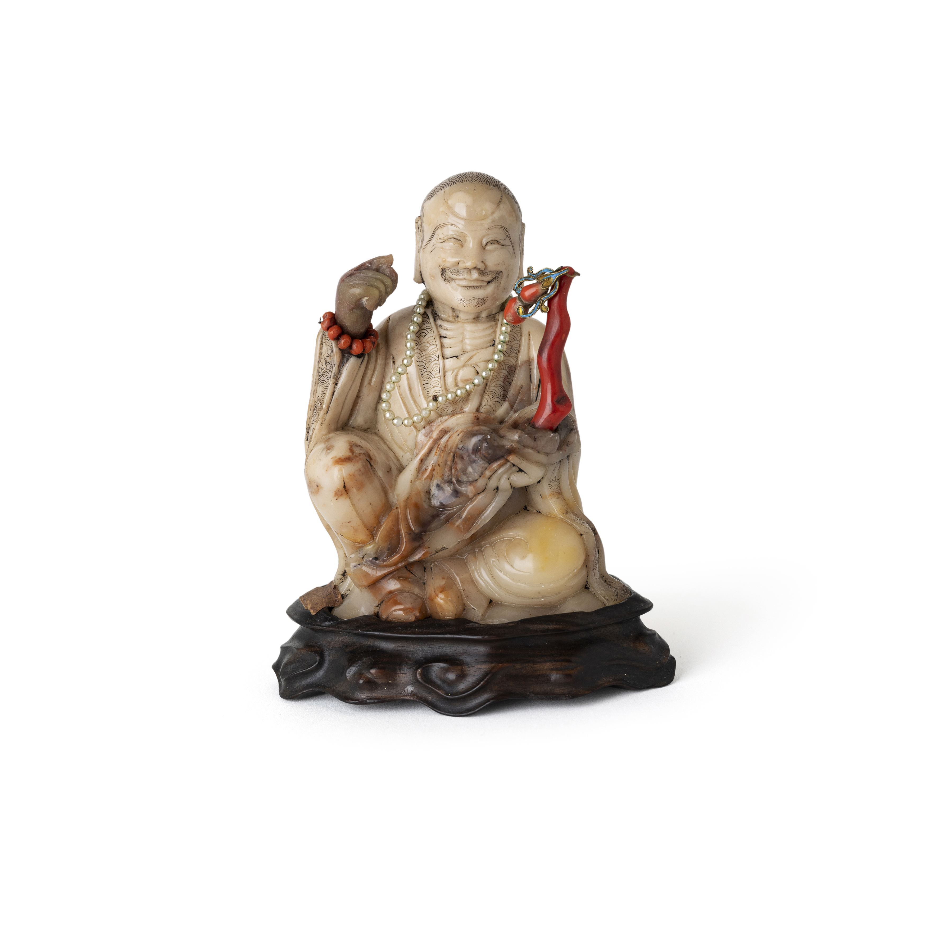 A Chinese soapstone figure of a seated luohan Qing dynasty, 18th century Finely carved with a s...
