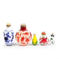 Five Chinese overlay snuff bottles Qing dynasty, 19th century - 20th century Comprising: a dark...