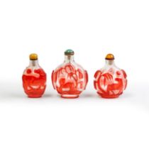 Three Chinese red overlay translucent glass 'horses' snuff bottles Qing dynasty, 19th century O...