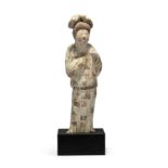 A Chinese painted pottery figure of a court lady Tang dynasty Modelled standing swaying slightl...