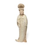 A Chinese pottery figure of a court lady Tang dynasty Modelled standing swaying to the left wit...