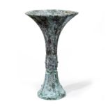 A Chinese bronze Shang style vase, Gu 20th century Cast to the flared neck with vertical stiff ...