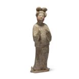 A Chinese painted pottery figure of a court lady Tang dynasty Her hair put up in an elaborate h...