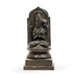 A Chinese bronze figure of Guanyin Late Qing dynasty/20th century Cast seated in padmasana over...