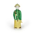 A Chinese famille verte biscuit figure of a young scholar Qing dynasty, Kangxi period Wearing a...