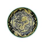 A Chinese black ground 'five dragons' plate Republic period Raised on short tapered foot rising...