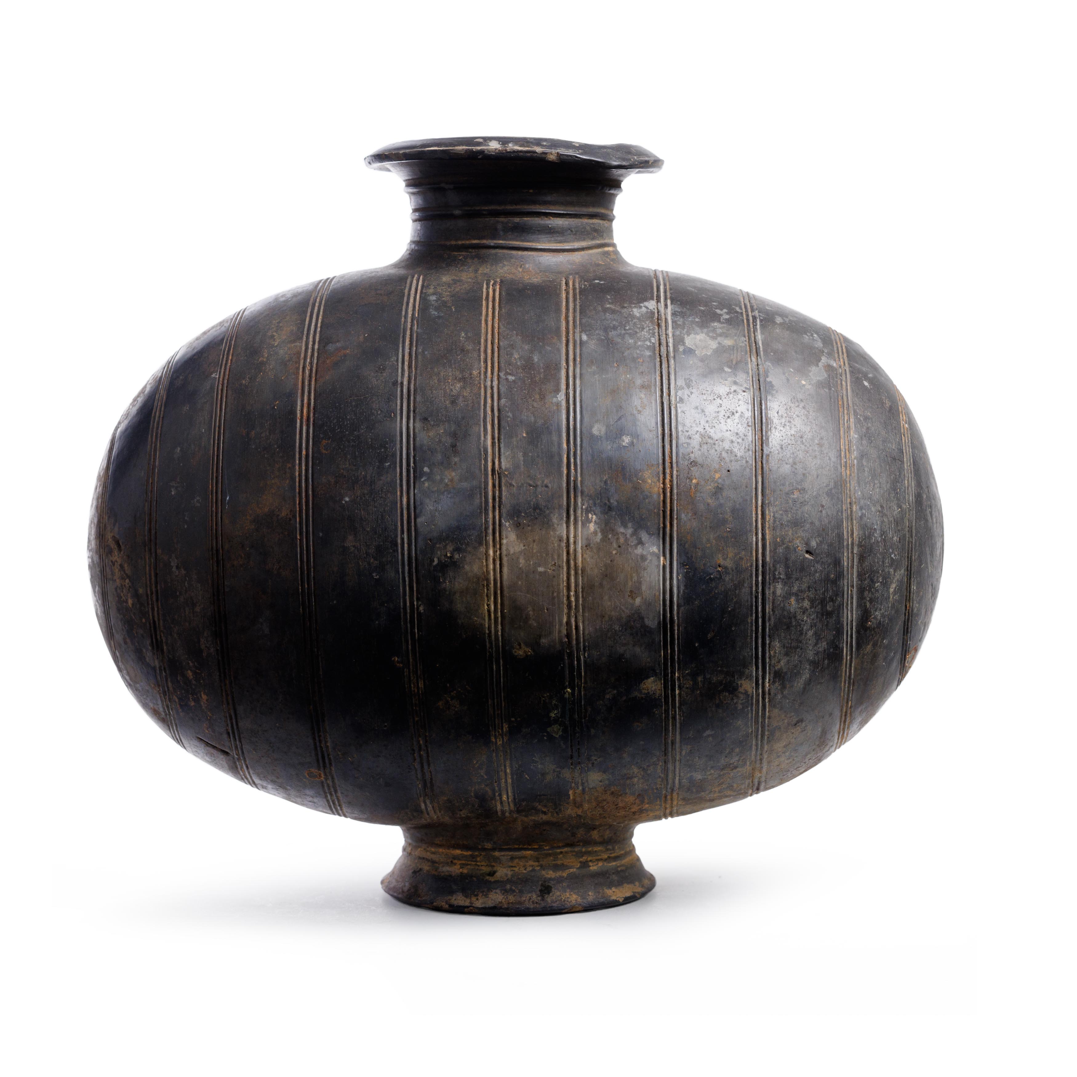 A rare large polished grey pottery cocoon shaped jar Han dynasty  Rising from the banded and fl...