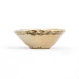 A small Chinese 'Swatow (Zhangzhou) conical bowl 17th century The buff body covered overall in ...