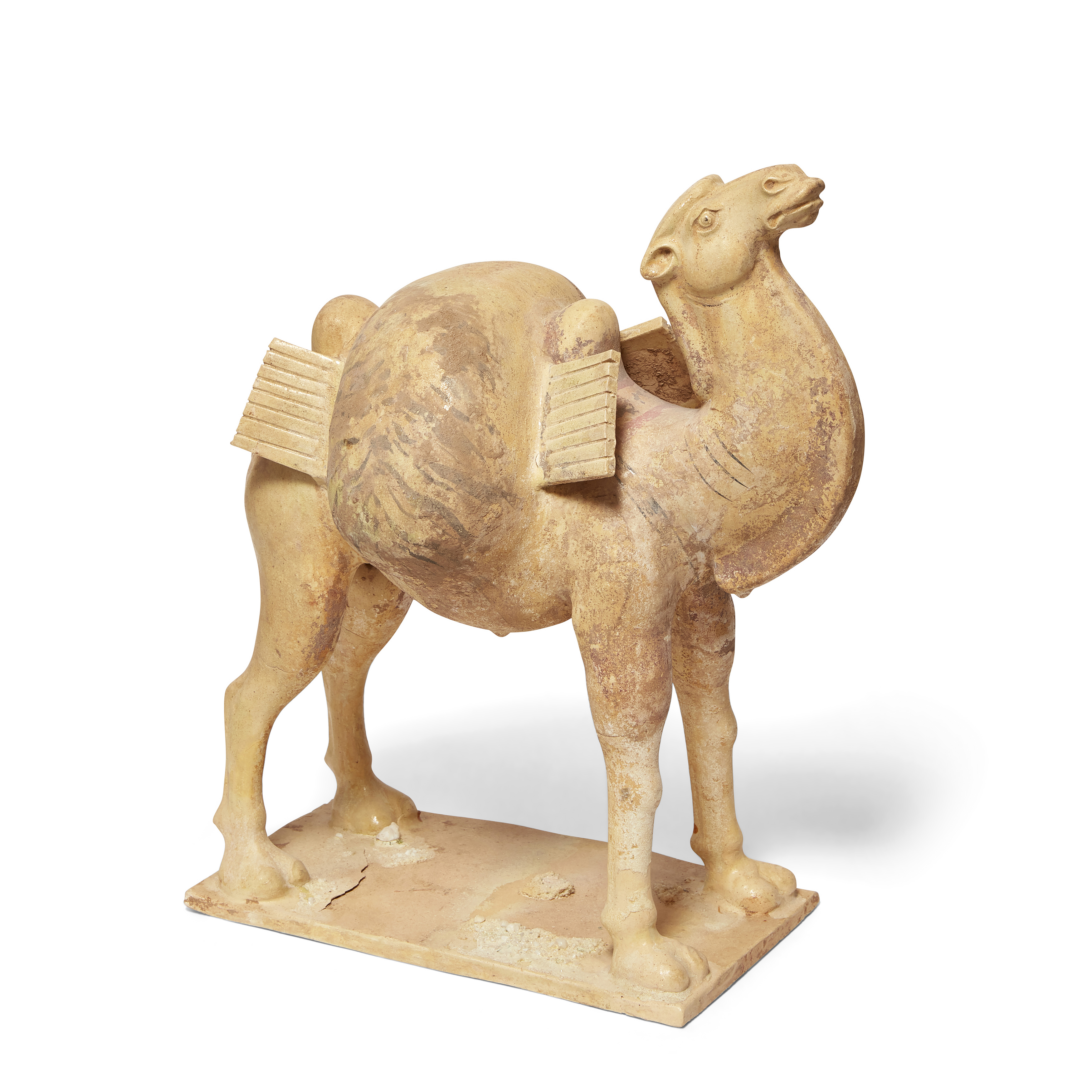 A Chinese glazed pottery figure of a camel  Tang dynasty Naturalistically modelled standing on ...