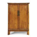 A Chinese elm cabinet Early 20th century With pair of rectangular panel doors and central stile...