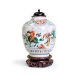 A Chinese wucai ovoid jar Late Qing dynasty Decorated with figures in a procession in a continu...