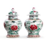 A pair of Chinese famille rose 'peonies' baluster jars and covers Late Qing dynasty Each bright...