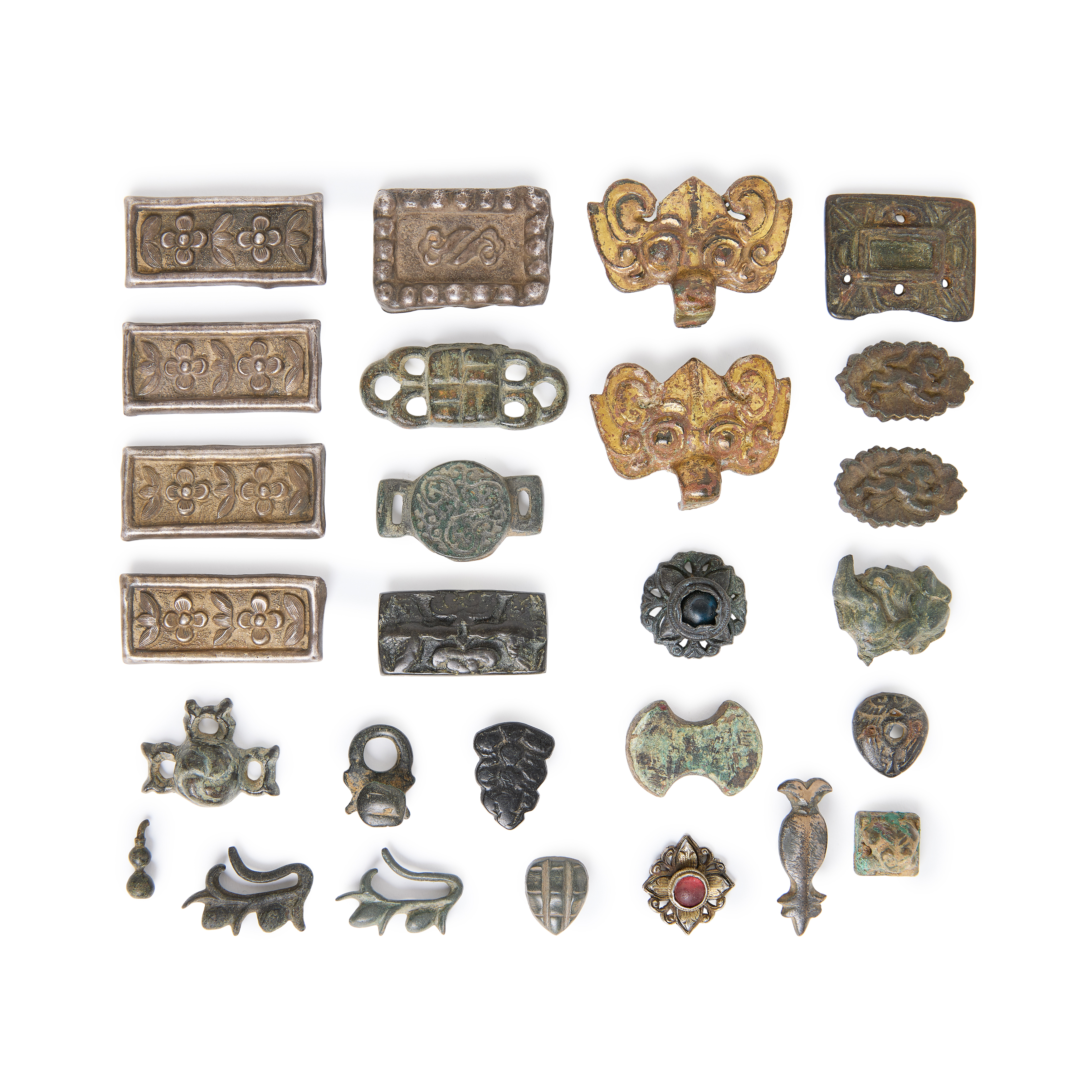 A group of thirty Chinese gilt bronze, bronze and white metal ornaments 18th - 20th century Com...