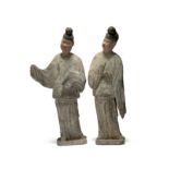 Two rare Chinese painted pottery figures of eunuchs Tang dynasty Wearing black court hats, thei...