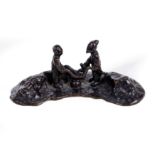 A Chinese bronze figurative brush rest Ming dynasty Cast with an old man and a boy standing in ...