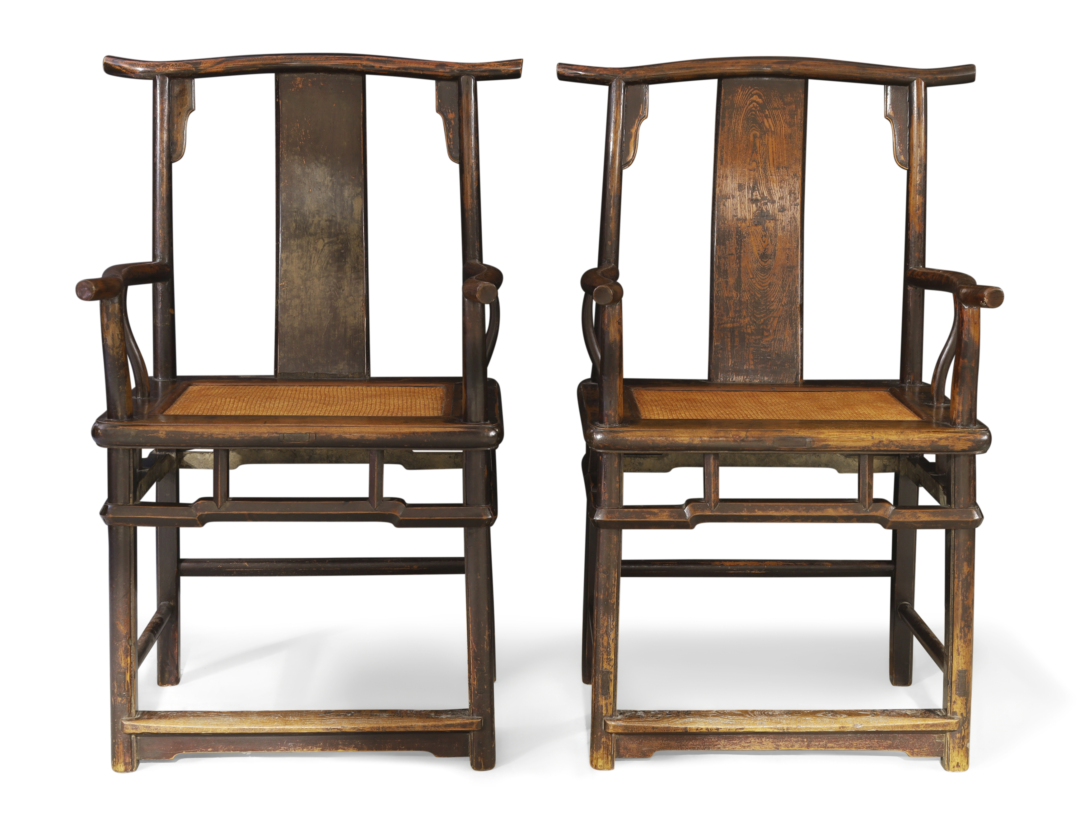 A pair of Chinese provincial lacquered elm yoke back armchairs, Qing dynasty, 18th century With...
