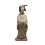A Chinese painted pottery figure of a court lady Tang dynasty Standing gazing to her left with ...