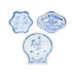 Three Chinese export blue and white saucers Qing dynasty, 18th century  Comprising a scallop-sh...