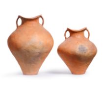A large Chinese red pottery jar and two 'saddle-mouth' handled jars, Siwa culture Bronze Age, c....