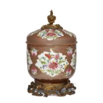 A Chinese café-au-lait and famille rose bowl and cover with European gilt-bronze mounts The porc...
