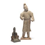 A Chinese pottery figure of a groom and a pottery figure of a seated woman winnowing Tang and Su...