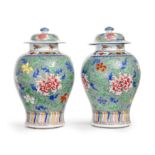 A pair of Chinese famille rose and wucai baluster jars and covers Late Qing dynasty Each painte...