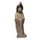 A Chinese pottery figure of a court lady Tang dynasty Modelled standing and swaying to the righ...