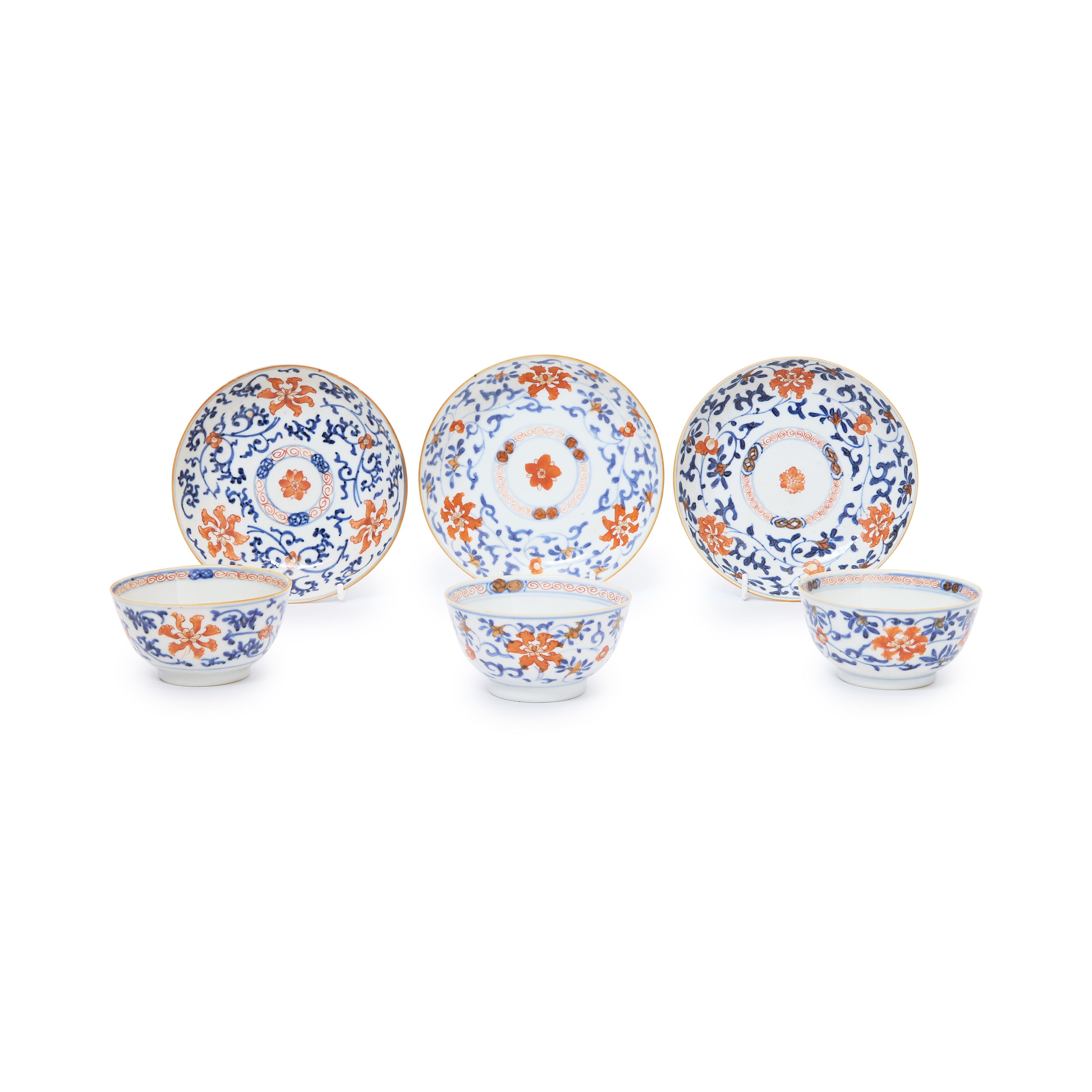 Three sets of Chinese iron red and blue and white tea bowls and saucers Qing dynasty, 19th centu...