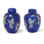 A pair of Chinese powder blue-ground famille verte jars and covers Late Qing dynasty/Republic pe...