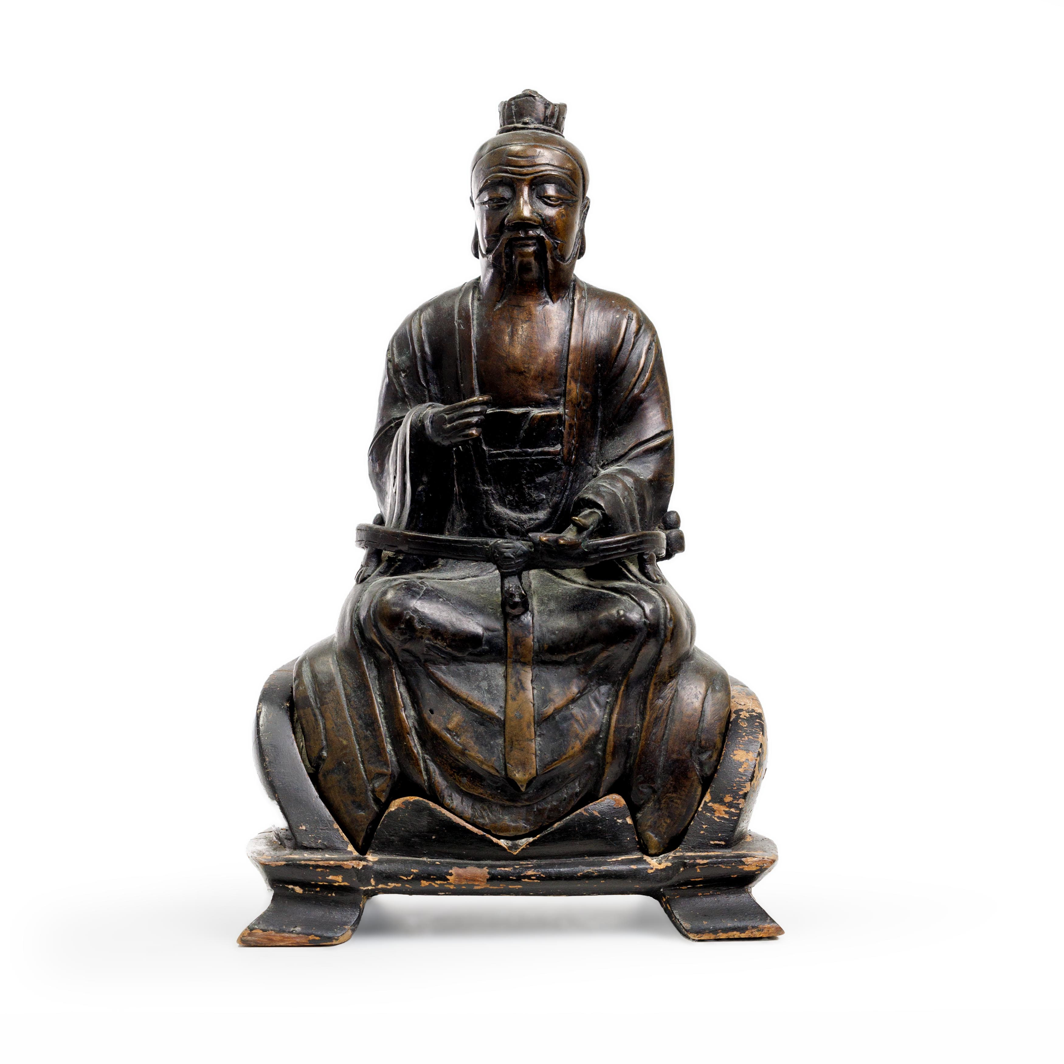 A Chinese bronze documentary figure of a seated official or Daoist deity Ming Dynasty, dated by ...