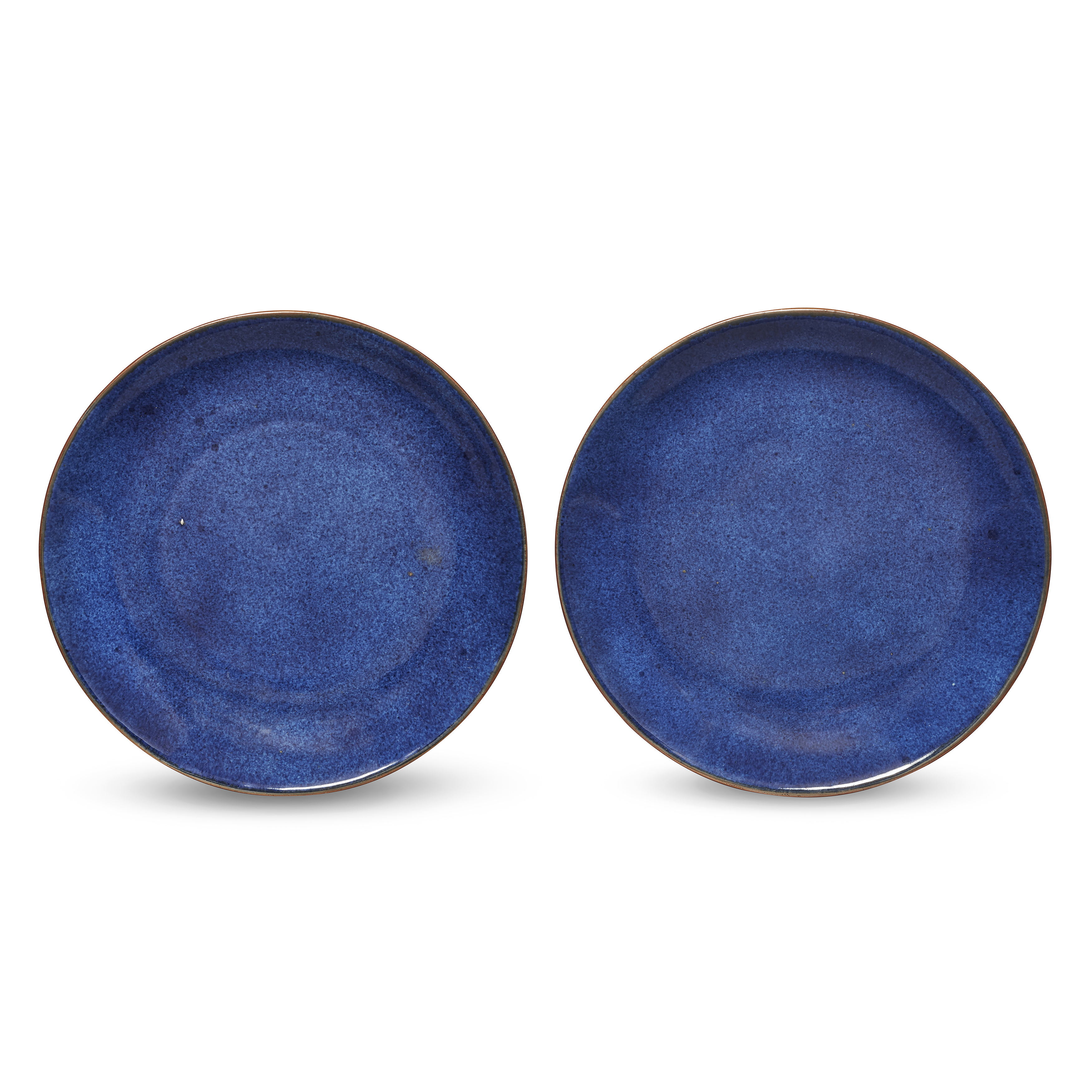 A pair of Chinese powder-blue-glazed dishes Qing dynasty, Kangxi period Each raised on short ta...