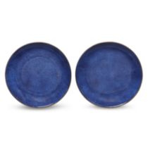 A pair of Chinese powder-blue-glazed dishes Qing dynasty, Kangxi period Each raised on short ta...