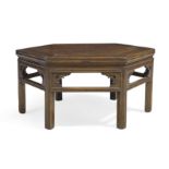 A Chinese elm hexagonal low table, Early 20th century With carved open frieze raised on fluted ...