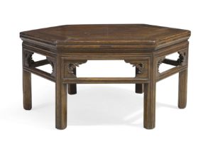 A Chinese elm hexagonal low table, Early 20th century With carved open frieze raised on fluted ...