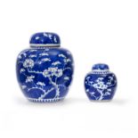 Two Chinese blue and white prunus jars and covers Qing dynasty, 19th century Each similarly pai...