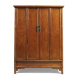 A large Chinese elm tapered cupboard Late Qing dynasty With four rectangular panel doors enclos...