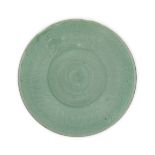 A large Chinese celadon glazed dish Qing dynasty, 19th century The shallow vessel raised on a s...