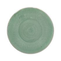 A large Chinese celadon glazed dish Qing dynasty, 19th century The shallow vessel raised on a s...