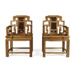 A pair of Chinese elm armchairs Late Qing dynasty The pierced backs decorated with archaistic a...