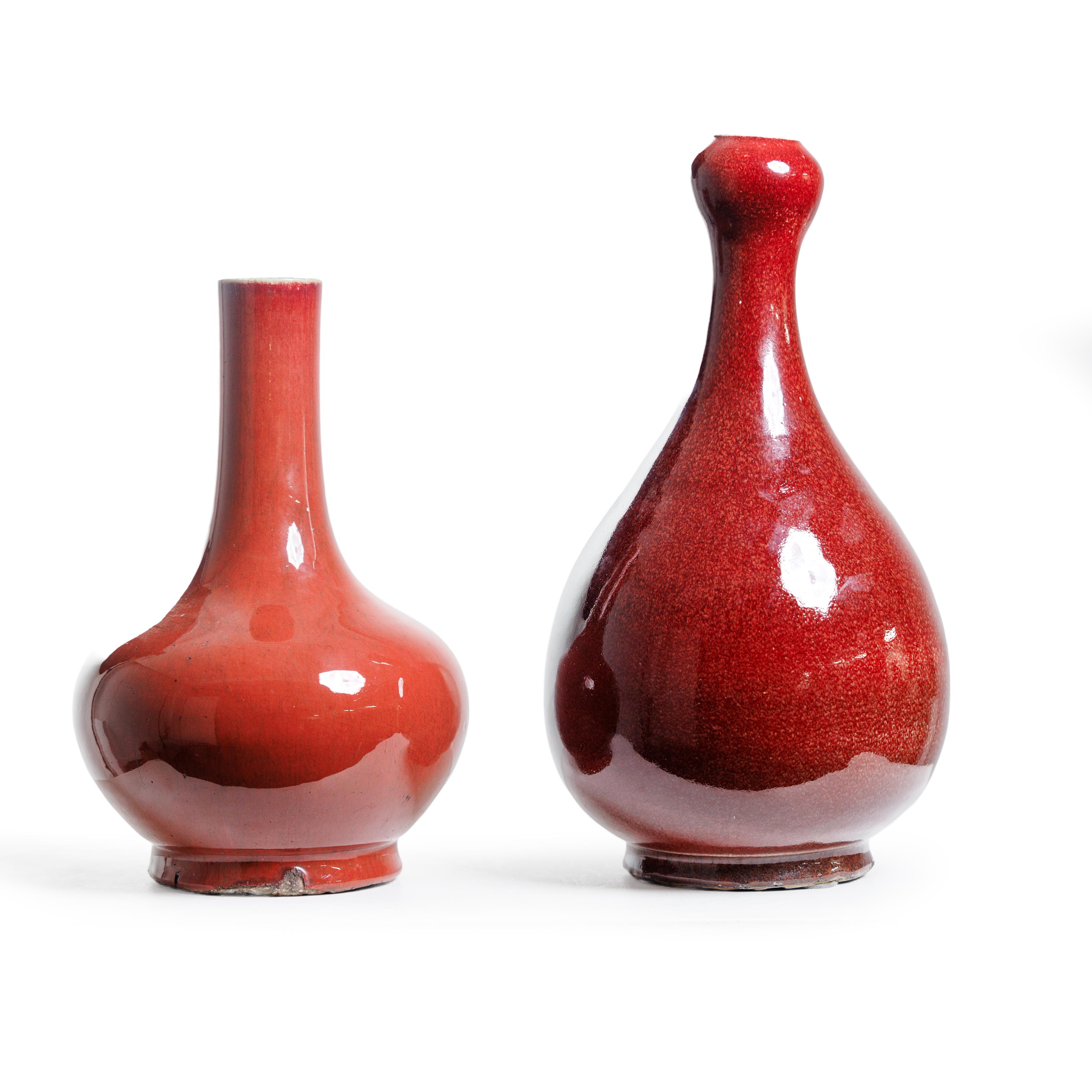 Two Chinese monochrome red-glazed vases Mid Qing dynasty The first, thickly potted in a pear-sh...