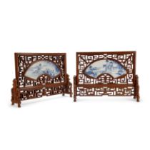 A pair of Chinese blue and white fan shaped table screens 20th century One decorated with two b...