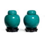 A pair of Chinese monochrome apple green glazed jars and covers, Late Qing dynasty Covered in a...