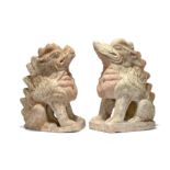 A pair of Chinese pottery Earth Spirit figures Tang dynasty Each modelled on their haunches wit...