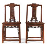 A pair of Chinese red painted hall chairs Republic period The central splat with carved rectang...