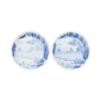 A pair of Japanese blue and white foliate rim dishes Meiji period Each raised on a short tapere...