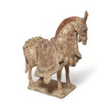 A Chinese polychrome painted figure of a caparisoned horse Norther Wei dynasty Modelled in a po...